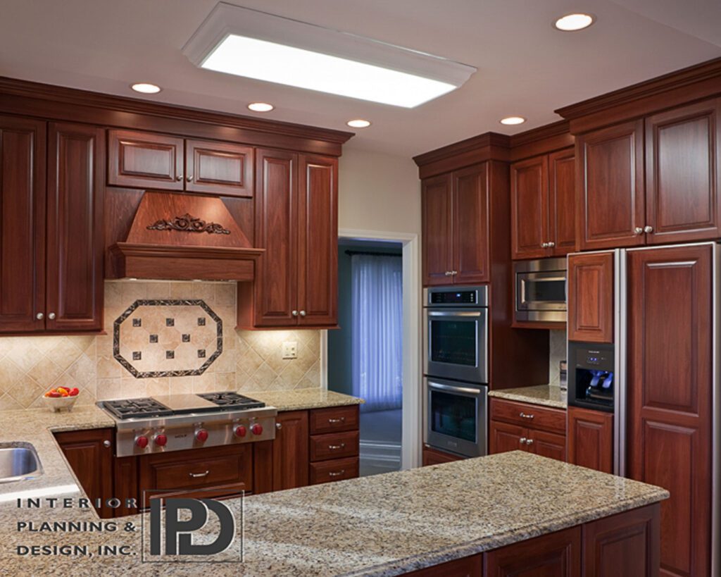 A kitchen area with brown cabinets
