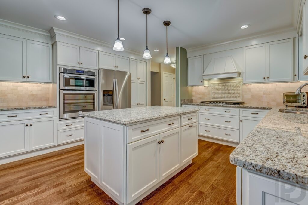 A kitchen area with white cabinets