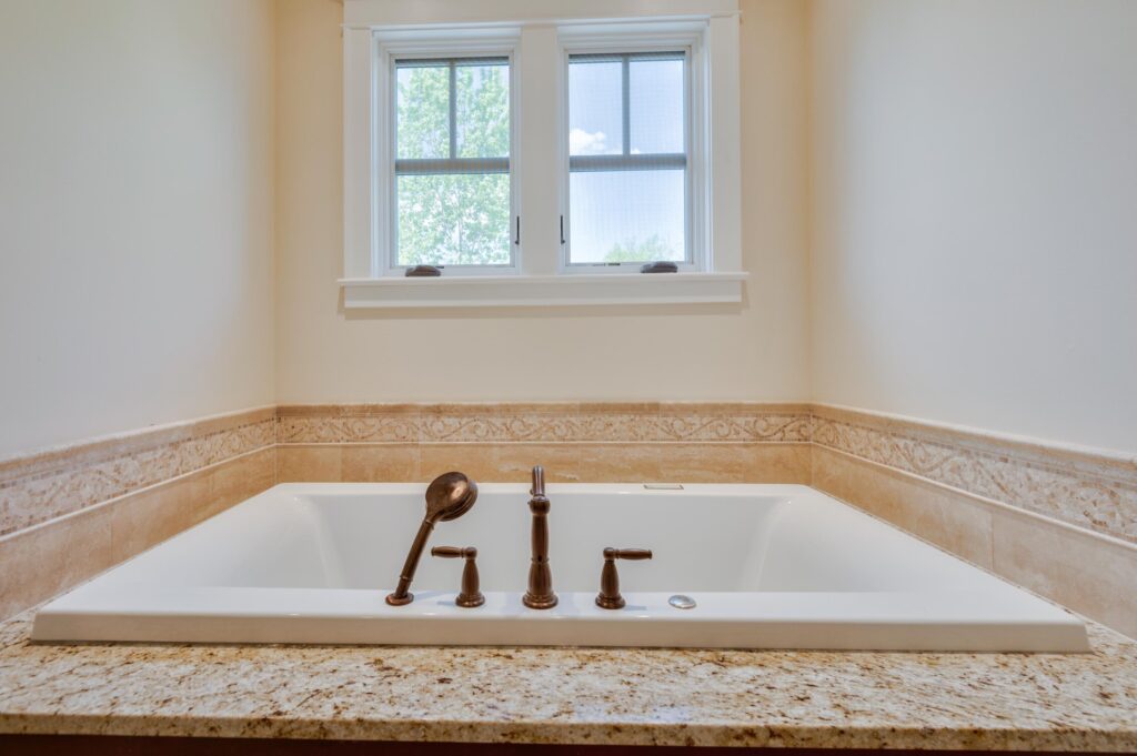 A bath tub with beige walls