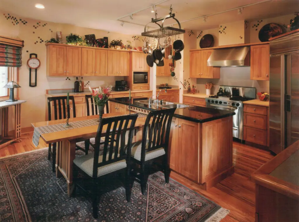 A wooden kitchen area and a dining table with four chairs
