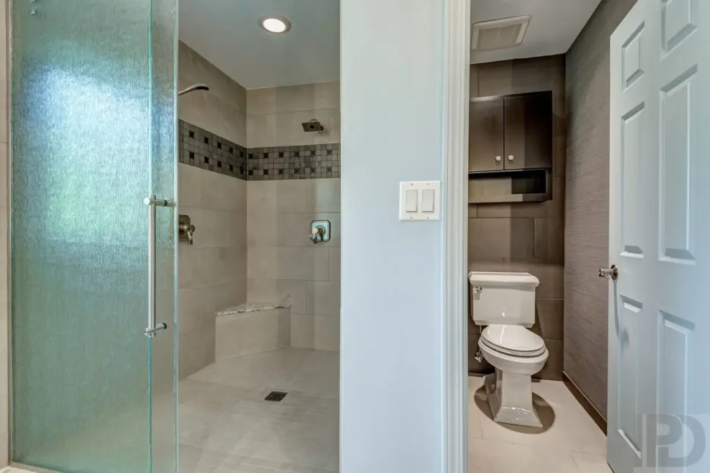 A shower area with glass doors